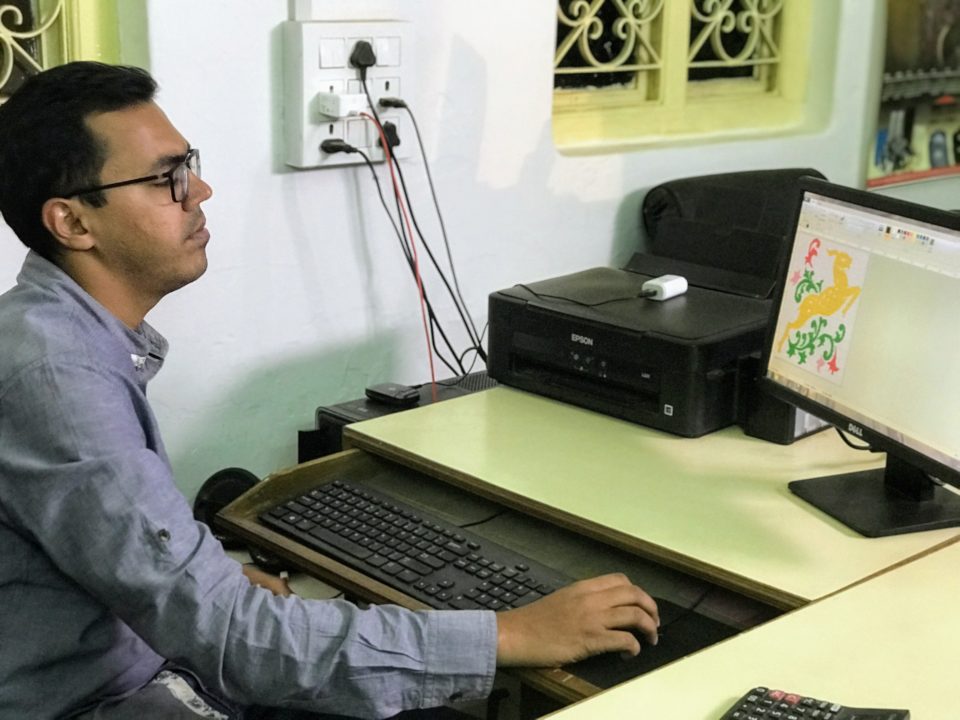 Aswin Somani working on motifs on his computer